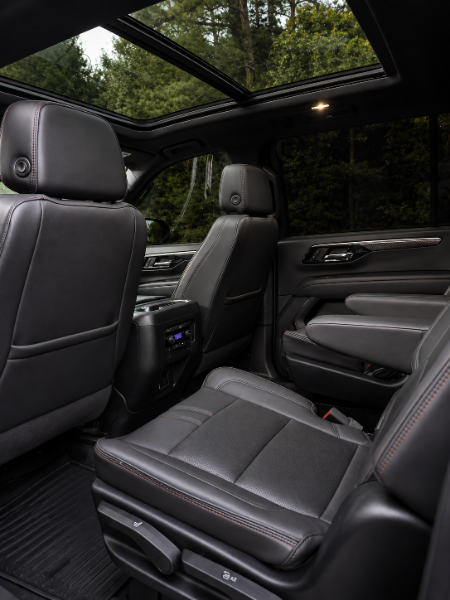 Chevrolet Suburban RST cabin looking up through the panoramic sunroof over diamond-stitched leather seating