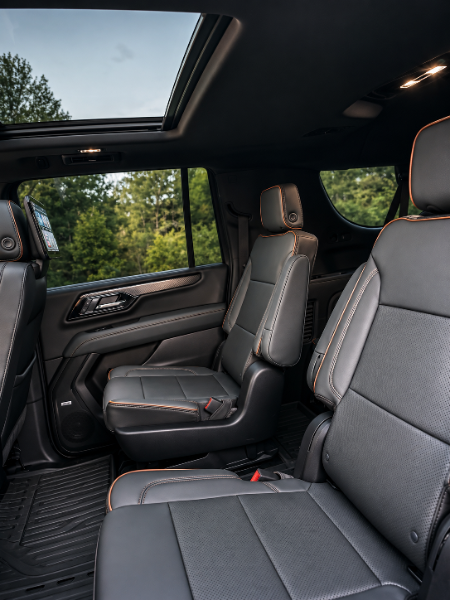 GMC Yukon AT4 second-row black leather captain's chairs beneath the panoramic sunroof