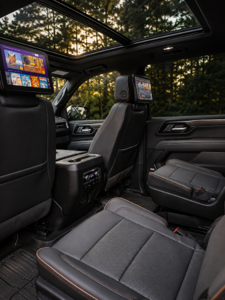 GMC Yukon AT4 rear cabin premium entertainment suite with dual screens and panoramic sunroof